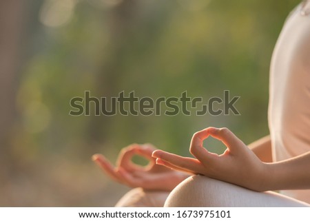 calmness and relax, female happiness.Horizontal, blurred background. little asian girl meditates while practicing yoga. freedom concept. calmness and relax, woman happiness. toned picture healthy life