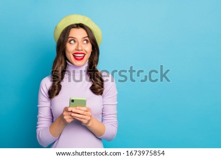 Portrait positive excited girl use smartphone want post social network news look copyspace enjoy thoughts scream wear style stylish trendy outfit red lips stick isolated blue color background