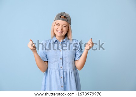 Cool happy young woman on color background