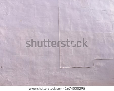 Texture of concrete wall of a house for background with space for runaround or wraparound text in pastel purple