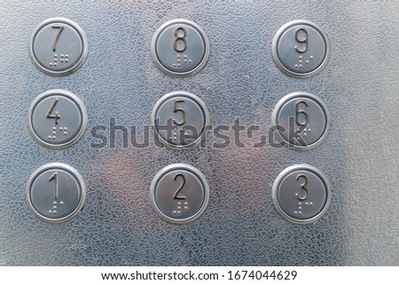 Elevator buttons with Braille close-up