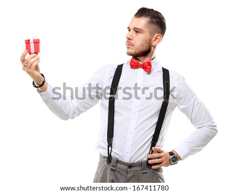 Excited happy smile man hold gift box in hand. Man present red gift box with ribbon bow Isolated over white background