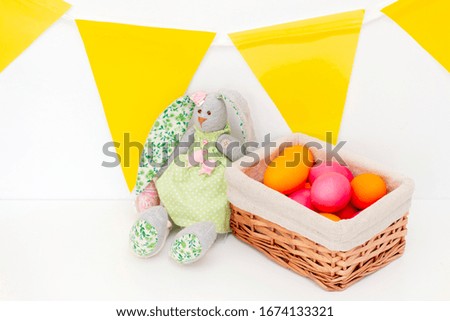 Easter eggs cute bunnies are in the basket. Happy easter. painted eggs on a light background.