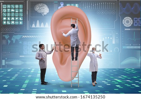 Doctor examining giant ear in medical concept