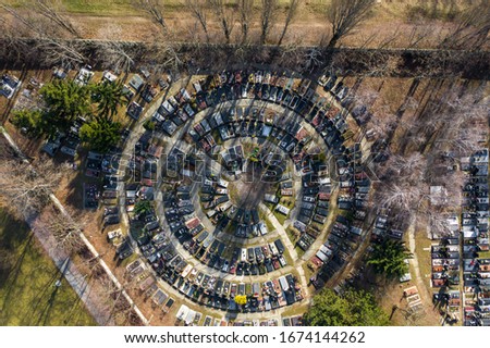 Beautiful aerial drone photo of circular shaped cemetery with graves and tombstones from above. Drone top down shot of cemetery design in gloomy setting. Top view of circular cemetery, birds eye view