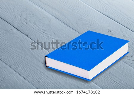 Blue hard cover book on the desk