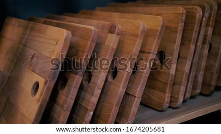 Wooden cutting boards standing on a shelf