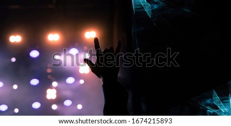 rock festival performance graphic design poster with abstract effect on black space for copy or your text here fan person hand on music stage background view with illumination glare and lights 