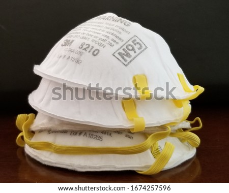 Stack of N-95 masks used by healthcare workers and in public demand during COVID-19 pandemic. Royalty-Free Stock Photo #1674257596