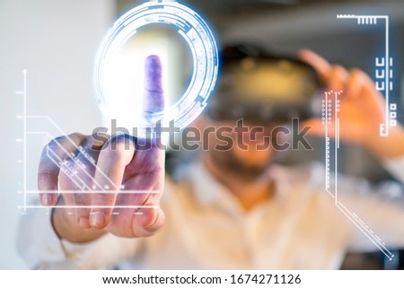 Man Wearing Virtual Reality Goggles in Office. Closeup of Male Hand. Playing Video Games with Virtual Reality Headset, Trying to Touch Something with Hand.