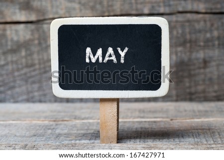 May on Small wooden framed blackboard with wooden background 