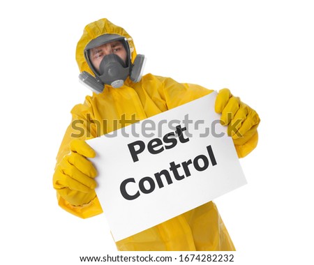 Man wearing protective suit holding sign PEST CONTROL on white background