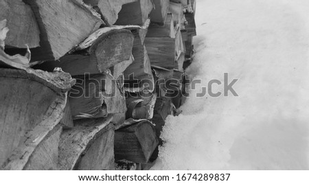 woodpile on snow black and white photo texture background