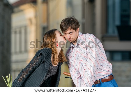 young woman kisses her boyfriend