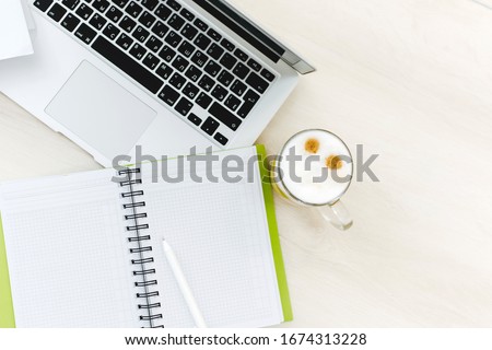 Top view office desk with laptop, notebooks and coffee cup on white color background. Office table with blank notebook and laptop