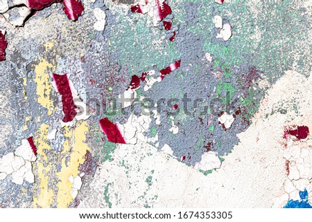 Fragment of colored graffiti painted on a wall. Bright abstract backdrop for design with peeling paint.