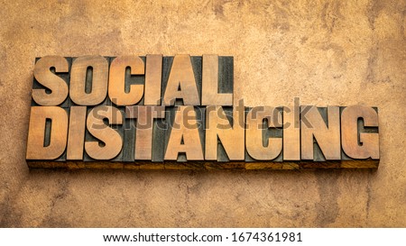 social distancing word abstract in vintage letterpress wood type - a set of nonpharmaceutical infection control actions to stop or slow down the spread of a contagious disease. Royalty-Free Stock Photo #1674361981