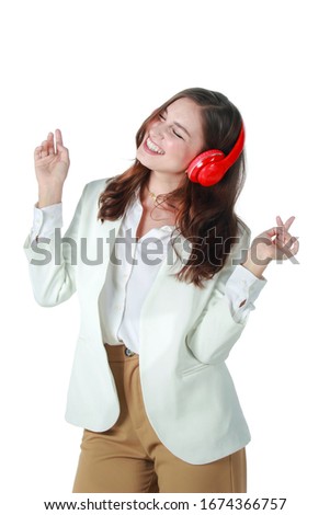 Portrait of young beautiful relaxing woman listening to music isolated on white background. Happy female wearing wireless headphones.