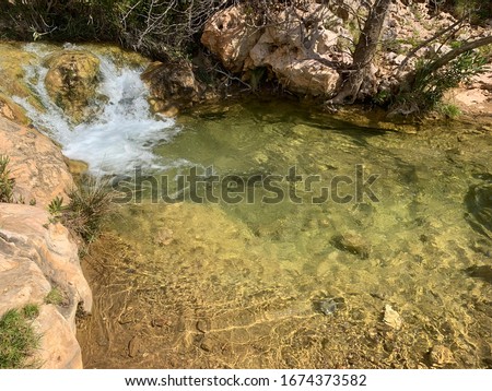 Photo of beautiful river flowing as waterfall at spring