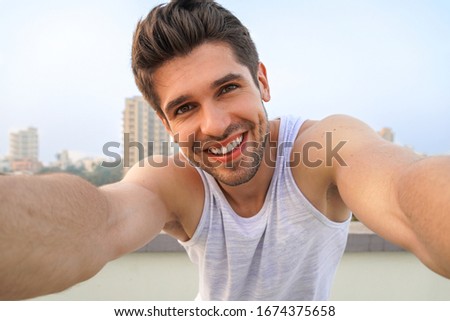 Young good-looking man is taking a Selfie on the roof Royalty-Free Stock Photo #1674375658