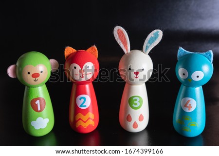 collection of wooden animal toys on a black background
