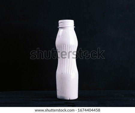 
yogurt in a white bottle is on the table