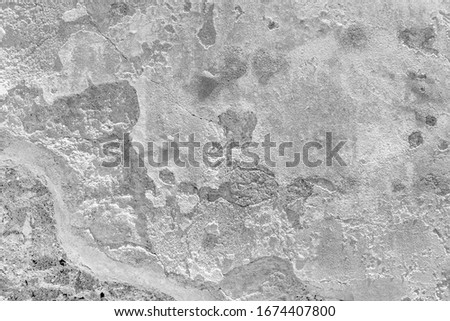 Destroyed chipped wall of farm house. Black white exterior urban facade. Whitewashed ruined structure background. Grunge uneven old stone rock texture. Outside crack crash cement mortar for 3d design