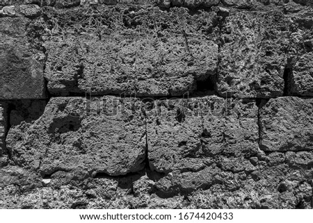 Age coarse shabby city masonry (backdrop). Crumbled black and white house cellar. Bumpy vintage facing castle fortress 3D design. Dirty rural facade of fortified tower, damp mold destroy ground floor