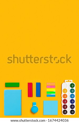 School supplies on yellow vertical background. Back to school picture.