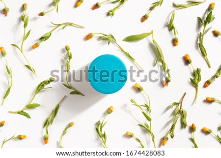 Organic cosmetic concept. Flowers of calendula and cosmetic cream isolated, on white background. Flat lay, top view
