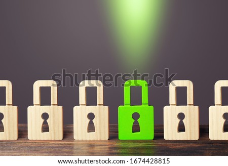 A green padlock stands out from others. Safety of personal data, privacy of users. NSFW. Virus, antivirus. Protecting information and avoiding unauthorized access and data leakage. Hacking attack. Royalty-Free Stock Photo #1674428815