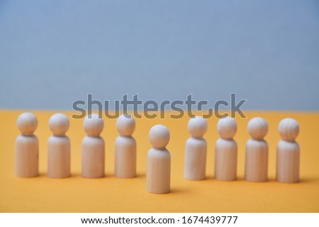 Thinking outside the box. Individual approach. Leadership and individuality. Wooden person figure stands out from crowd Royalty-Free Stock Photo #1674439777