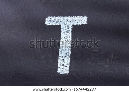 Letter T of the alphabet written with chalk