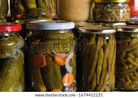 Jar filled with cucumbers, beans, meat mixture, etc. Preserved vegetables in jars, stock for winter.