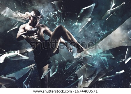 Portrait of a boxer of mixed martial arts, who smashes a mirror with his knee. The concept of sport, mma, kickboxing. Mixed media Royalty-Free Stock Photo #1674480571