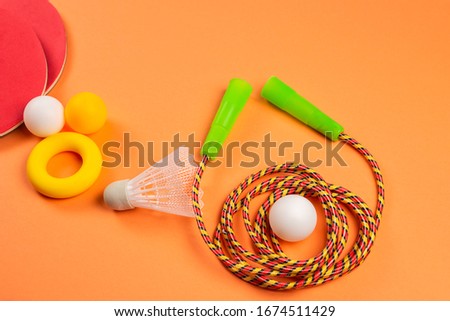 Sport equipment on orange background. Copy space. 