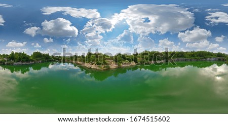 360-degree panoramic view above the water of a granite quarry with water