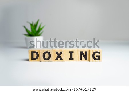 doxing concept, word on wooden cubes. Security concept.