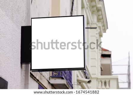 Empty signage modern blank mock up hanging city street with copy space 