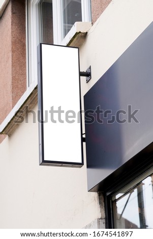 vertical white signage on shop front street