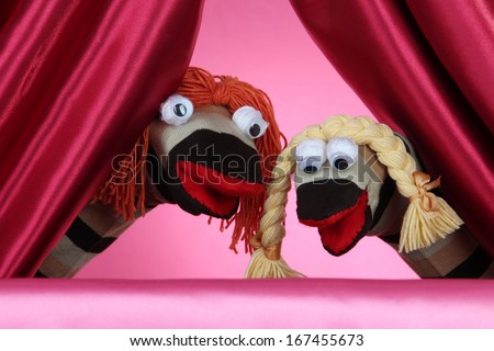 Puppet show on pink background Royalty-Free Stock Photo #167455673
