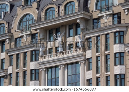 Facade of a luxury hotel decorated with statues. Architecture