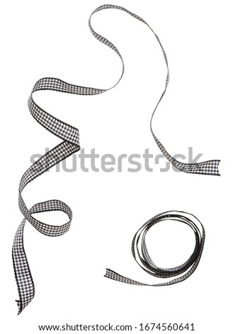 Black check ribbon curl isolated on white background. Black plaid ribbon bow and curl isolated on white background