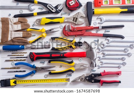 Set of hand tools . Equipment on wooden background Royalty-Free Stock Photo #1674587698
