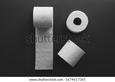 Toilet paper rolls on a black background. Toilet tissue.
 Royalty-Free Stock Photo #1674617365