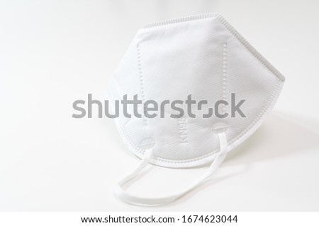 One KN-95 protection medical mask isolated on white background. Prevention of the spread of virus and epidemic, protective mouth filter mask. Diseases, flu, air pollution, corona virus concept Royalty-Free Stock Photo #1674623044
