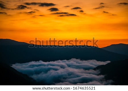 Mountains fog landscape clouds in morning above new river gorge valley in Grandview Overlook, West Virginia during morning colorful sunrise