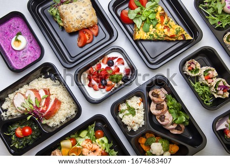 Catering food with healthy balanced diet delicious lunch box boxed take away deliver packed ready  meal in black container dinner, meal, brakfast Royalty-Free Stock Photo #1674683407