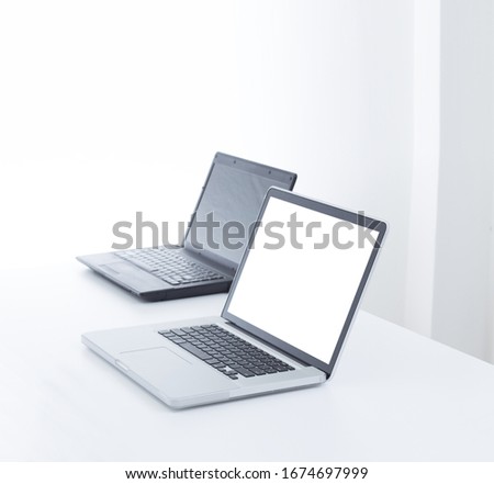 Laptop computer on desk with isolated screen for mockup.