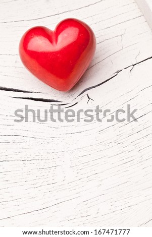 Valentines Day. Red heart on a white wooden table.